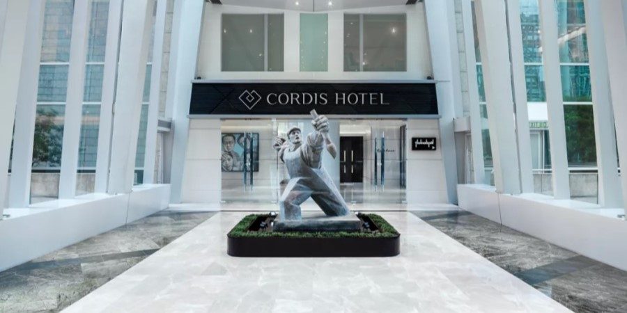 The Crescent Hotel lobby entrance at Cordis, Hong Kong, highlighting modern architecture and a warm welcome.